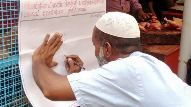 man in cap writing on a large piece of paper pinned to a wall